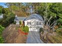 Aerial view showcasing a two-story home with mature trees, a private driveway, and a well-maintained landscape at 7470 Lake Marsha Dr, Orlando, FL 32819