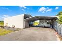 Large carport and storage building, offering ample parking and storage space, and a partially fenced yard at 8218 Pine Island Rd, Clermont, FL 34711