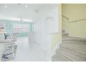 Bright living room featuring tile floors and staircase at 9635 Fenrose Ter, Orlando, FL 32827