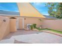Enclosed brick paved patio features drought resistant landscaping and shade sail at 9635 Fenrose Ter, Orlando, FL 32827