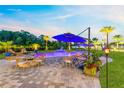 Relaxing backyard pool with comfortable seating around the brick firepit for outdoor relaxation at 9877 Laurel Berry Dr, Orlando, FL 32827