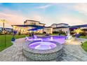 Stunning backyard pool and spa with a soothing ambiance, surrounded by well-maintained landscaping at 9877 Laurel Berry Dr, Orlando, FL 32827