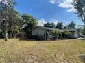 Cozy single-story house boasts well-kept lawn, fenced yard, screened porch, and lovely landscaping at 1001 Arden St, Longwood, FL 32750