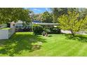 Spacious backyard featuring lush lawn, mature trees, and privacy fence at 101 E Lauren Ct, Fern Park, FL 32730