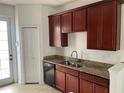 Kitchen with wooden cabinets, granite countertops and a double sink at 10128 Hartford Maroon Rd, Orlando, FL 32827