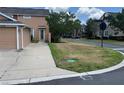 View of the property showing a driveway and nearby street intersection in a quiet neighborhood at 10128 Hartford Maroon Rd, Orlando, FL 32827