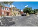 Charming townhome with easy access to parking, complemented by mature trees and tropical landscaping at 1041 Park Ridge Cir, Kissimmee, FL 34746
