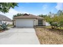 Inviting single-story home with a large front yard and attached garage at 11113 Sylvan Pond Cir, Orlando, FL 32825