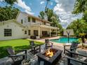 Outdoor living space featuring a pool, fire pit, and artificial turf at 11335 Winston Willow Ct, Windermere, FL 34786