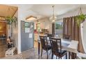 Cozy dining room adjacent to kitchen features stylish chandelier and comfortable seating at 1219 Blue Spring Ct, Ocoee, FL 34761