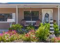 Inviting front porch with lovely landscaping, charming decor, and outdoor seating at 1219 Blue Spring Ct, Ocoee, FL 34761