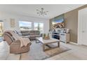 Comfortable living room featuring a sectional sofa, modern lighting, and neutral tones at 1312 Axel Graeson Ave, Kissimmee, FL 34744