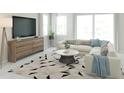 Bright living room with large windows, comfortable seating, and contemporary décor at 13248 Pergola Ave, Orlando, FL 32832
