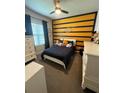 bedroom with nautical theme decor, including a custom painted wall, window, and furnishings at 13299 Serene Valley Dr, Clermont, FL 34711