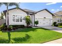 Well-maintained lawn complements the home's facade, enhancing its curb appeal at 13299 Serene Valley Dr, Clermont, FL 34711