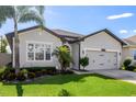 Beautiful curb appeal with a manicured lawn and fresh landscaping at 13299 Serene Valley Dr, Clermont, FL 34711