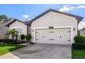 Garage and well-manicured lawn create an inviting curb appeal at 13299 Serene Valley Dr, Clermont, FL 34711