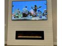 Contemporary fireplace with large screen television for home entertainment at 13299 Serene Valley Dr, Clermont, FL 34711