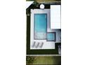Aerial view of a backyard featuring a pool, spa, lounge chairs and turf at 13299 Serene Valley Dr, Clermont, FL 34711