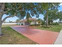 Long driveway with a patterned brick design leading to this well-kept residential home at 1441 Olde Kensington Ln, Deltona, FL 32725