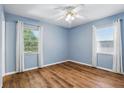 Bedroom featuring wood floors, two windows with neutral paint and natural light at 17 W Nightingale St, Apopka, FL 32712