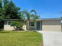 Charming home featuring a fresh lawn, a palm tree, and a newly installed concrete driveway at 2514 Highlawn Ave, Sanford, FL 32773