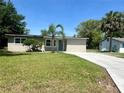 Charming home featuring a fresh lawn, a palm tree, and a newly installed concrete driveway at 2514 Highlawn Ave, Sanford, FL 32773