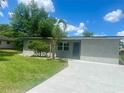 Charming single story home boasts lush green lawn, freshly painted exterior, and newly laid concrete driveway at 2514 Highlawn Ave, Sanford, FL 32773