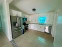 Modern kitchen with stainless steel appliances and sleek, white cabinets at 2514 Highlawn Ave, Sanford, FL 32773