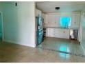 Modern kitchen with stainless steel appliances and sleek, white cabinets at 2514 Highlawn Ave, Sanford, FL 32773