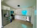 Modern kitchen with stainless steel appliances and sleek, white cabinets at 2514 Highlawn Ave, Sanford, FL 32773