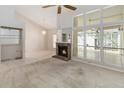 Open-concept living room featuring a brick fireplace and lots of natural light at 262 W Sabal Palm Pl, Longwood, FL 32779