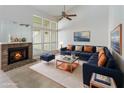 Bright living room with fireplace, large windows and a comfortable blue sectional couch at 262 W Sabal Palm Pl, Longwood, FL 32779