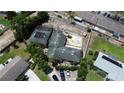 Aerial view of a large property with an in-ground pool, surrounded by lush greenery and a driveway with parked cars at 300 Broadview Ave, Altamonte Springs, FL 32701