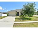 Attractive one-story home with a well-manicured front lawn, offering great curb appeal at 35734 Rose Moss Ave, Leesburg, FL 34788