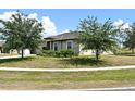 Well-kept one-story home with lush lawn and mature trees, perfect for enjoying the outdoors at 35734 Rose Moss Ave, Leesburg, FL 34788