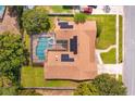 Aerial view of a single Gathering home with a screened-in pool and solar panels at 413 Sandy Hill Dr, Longwood, FL 32779