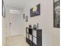 Inviting entryway with light tile flooring, a front door, and stylish decorations at 415 Anne St, Deland, FL 32724