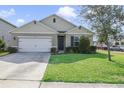 Charming single-story home with a lush green lawn and well-kept landscaping at 415 Anne St, Deland, FL 32724