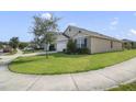 Well-manicured front lawn surrounds a charming single-story home, showcasing neighborhood street view and curb appeal at 415 Anne St, Deland, FL 32724