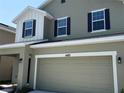 Two-story home featuring a two-car garage, and neutral color siding with black shutters at 4185 Sagefield Dr, St Cloud, FL 34773