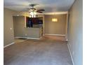 Cozy living room with ceiling fan and view of kitchen at 5164 Conroy Rd # 1526, Orlando, FL 32811