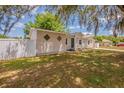 Charming single-story home with white fence and green lawn in the front yard at 1084 Doyle Rd, Deltona, FL 32725