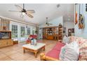 Inviting living room with tile flooring, ceiling fans, natural light, and access to the pool area at 1100 Oday Dr, Winter Springs, FL 32708