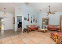 Cozy living room featuring tile floors, comfortable furniture, and unique guitar wall decor at 1100 Oday Dr, Winter Springs, FL 32708