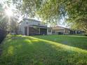 Expansive backyard with a well-maintained lawn and a screened-in porch perfect for outdoor relaxation and entertaining at 11742 Chateaubriand Ave, Orlando, FL 32836