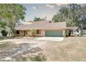 Beautiful single-story home with two-car garage, stone accents, and lovely front lawn with pergola at 12454 S Lake Mary Jane Rd, Orlando, FL 32832