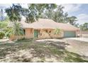 Attractive single-story house with stone accents, a two-car garage, and a well-maintained lawn at 12454 S Lake Mary Jane Rd, Orlando, FL 32832