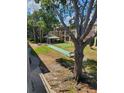 A view of the well-maintained condo grounds with mature trees, green spaces, seating, and building views at 131 Water Front Way # 200, Altamonte Springs, FL 32701