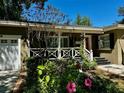 Welcoming exterior view showcasing landscaped garden, covered porch, and vibrant curb appeal at 1399 Aloma Ave, Winter Park, FL 32789